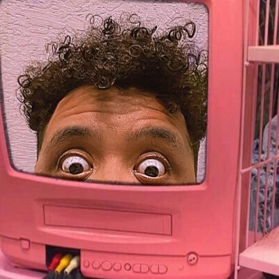 Photo of Gil Creque in a pink TV